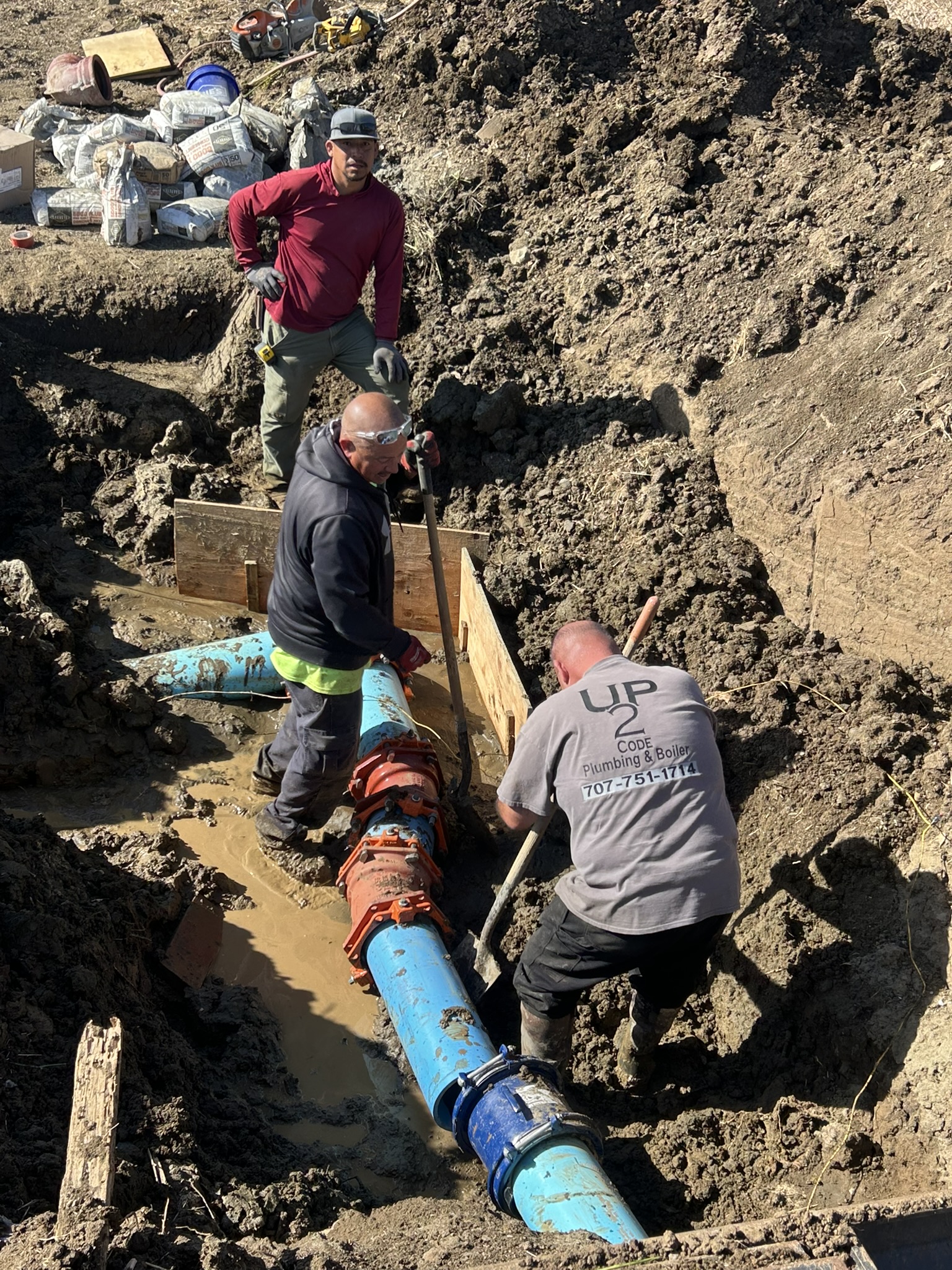 Plumbing contractor’s crew working at a Benicia school in the excavation prepared by ECI
